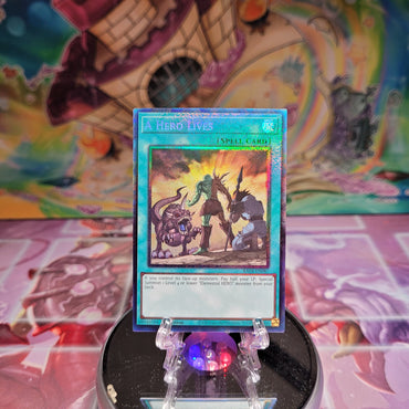 A Prismatic Collector's Rare "A Hero Lives" card from the Yugioh Set: Quarter Century Stampede (RA04).
