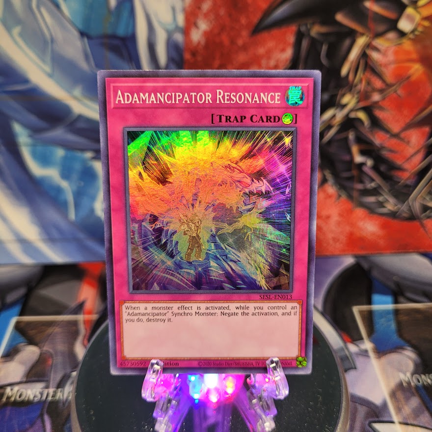  A Super Rare "Adamancipator Resonance" card from the Yugioh Set: Secret Slayers.