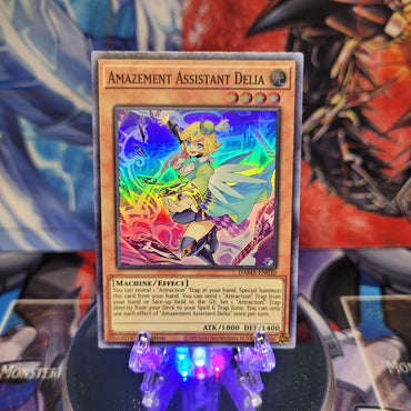 A Super Rare "Amazement Assistant Delia" card from the Yugioh Set: Dawn of Majesty.