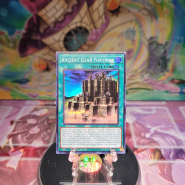 A Super Rare "Ancient Gear Fortress" card from the Yugioh Set: Quarter Century Bonanza (RA03).