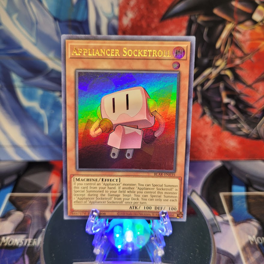 An Ultra Rare "Appliancer Socketroll" card from the Yugioh Set: Battles of Legend: Armageddon.