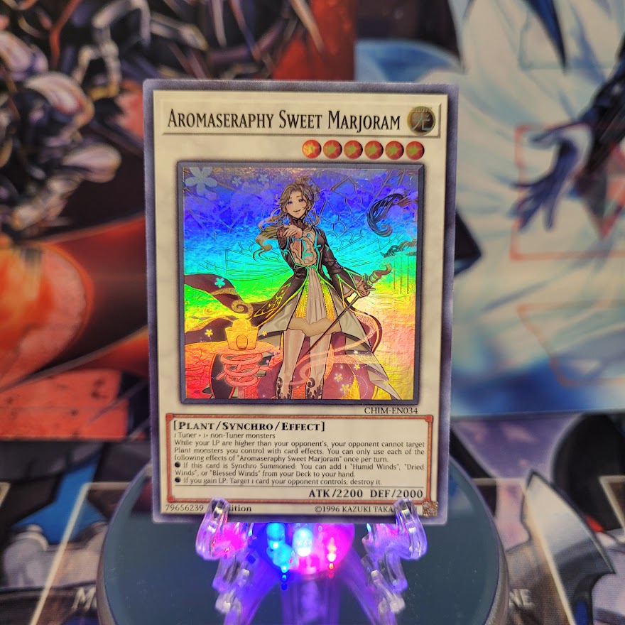 A Super Rare "Aromaseraphy Sweet Marjoram" card from the Yugioh Set: Chaos Impact.