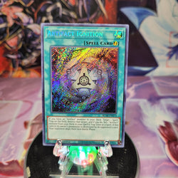 A Secret Rare "Artifact Ignition" card from the Yugioh Set: Battles of Legend: Armageddon (BLAR).