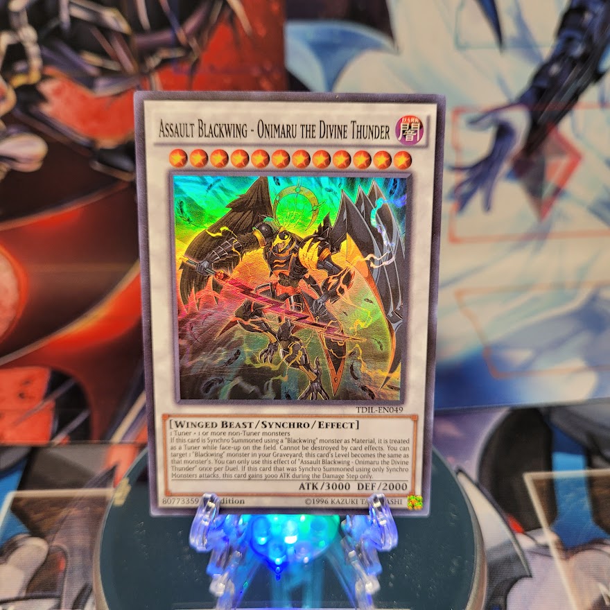 A Super Rare "Assault Blackwing - Onimaru the Divine Thunder" card from the Yugioh set: The Dark Illusion.