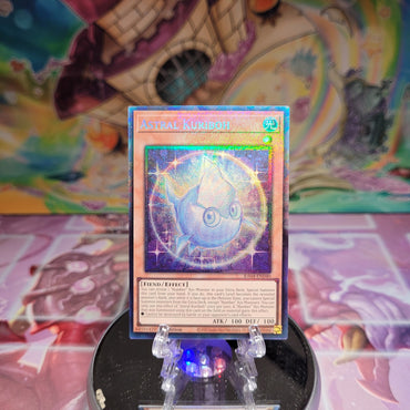 A Prismatic Collector's Rare "Astral Kuriboh" card from the Yugioh Set: Quarter Century Stampede (RA04).