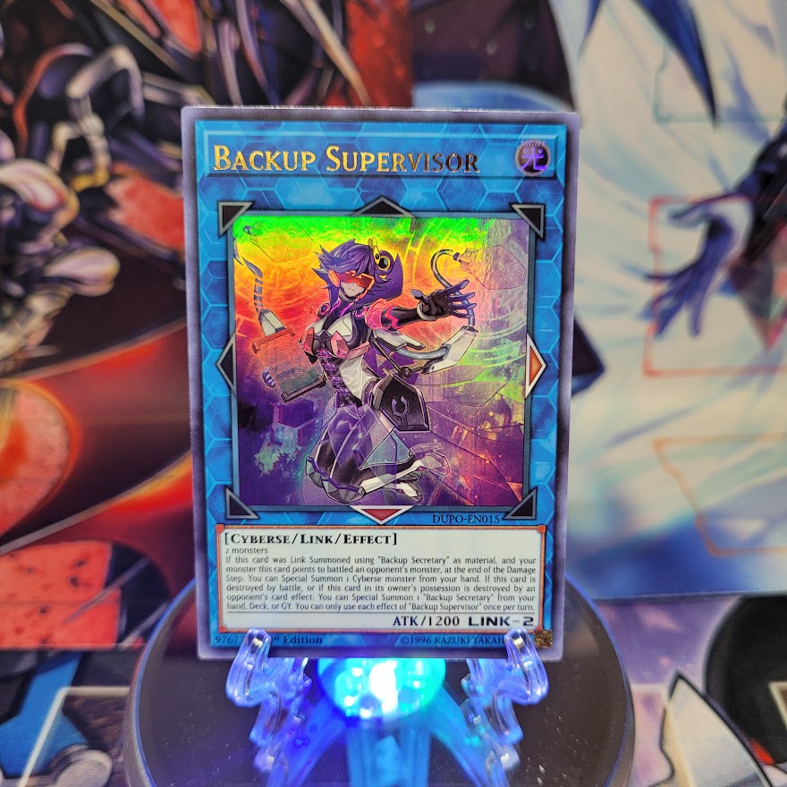 An Ultra Rare "Backup Supervisor" card from the Yugioh Set: Duel Power.