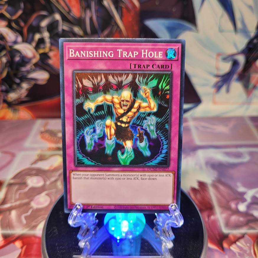 A Super Rare "Banishing Trap Hole" card from the Yugioh Set: Duelist Nexus. 