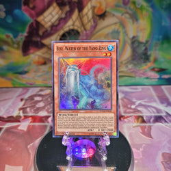 A Super Rare "Bixi, Water of the Yang Zing" card from the Yugioh Set: Duelist Alliance.