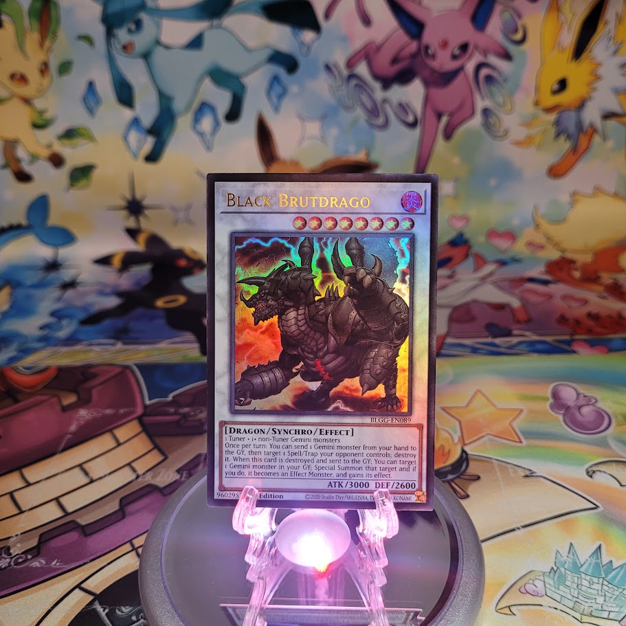 An Ultra Rare "Black Brutdrago" card from the Yugioh Set: Battles of Legend: Glorious Gallery (BLGG).