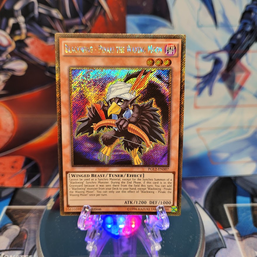 A Gold Secret Rare "Blackwing - Pinaki the Waxing Moon" card from the Yugioh set: Premium Gold: Return of the Bling.