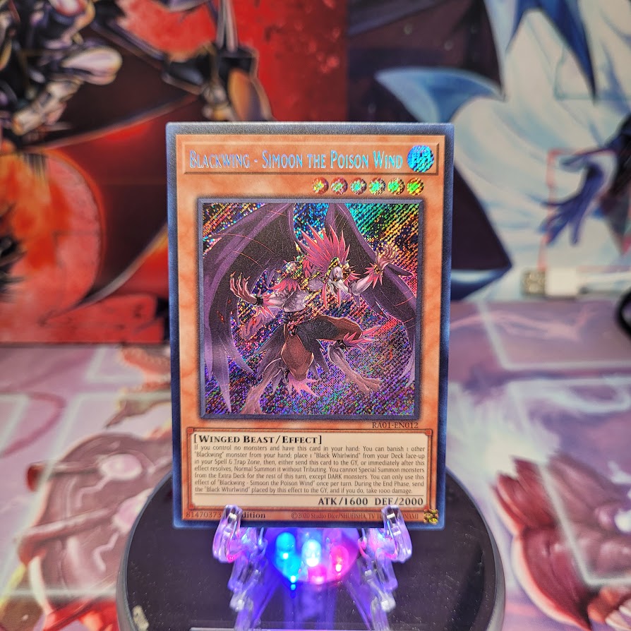 A Secret Rare "Blackwing - Simoon the Poison Wind" card from the Yugioh Set: Rarity Collection 1 (RA01).