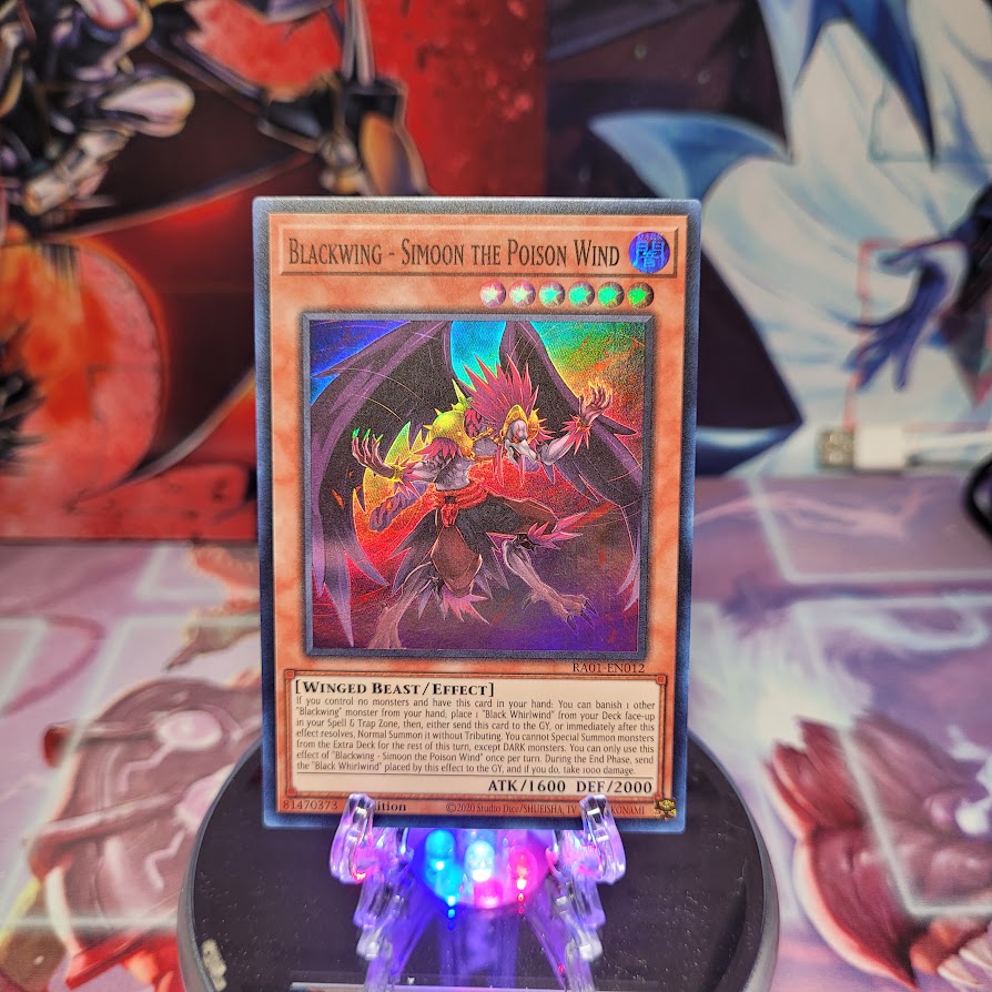 A Super Rare "Blackwing - Simoon the Poison Wind" card from the Yugioh Set: Rarity Collection 1 (RA01).