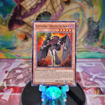 An Ultra Rare "Blackwing - Sirocco the Dawn" card from the Yugioh Set: Legendary Collection 5D's.