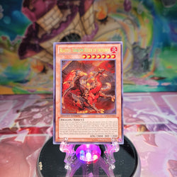 A Secret Rare "Blaster, Dragon Ruler of Infernos" card from the Yugioh 2013 Collectors Tins.