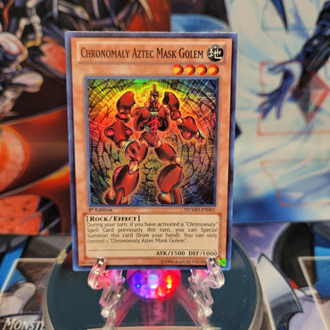 A Super Rare "Chronomaly Aztec Mask Golem" card from the Yugioh Set: Number Hunters.