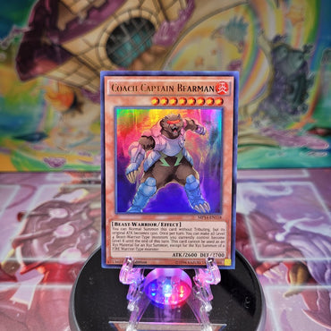 An Ultra Rare "Coach Captain Bearman" card from the Yugioh 2014 Mega-Tin Mega Pack set.