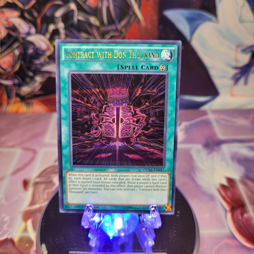  An Ultra Rare "Contract with Don Thousand" card from the Yugioh Set: Duelist Saga (DUSA).