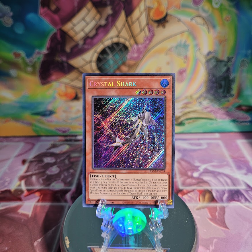 A Secret Rare "Crystal Shark" card from the Yugioh Set: Quarter Century Bonanza (RA03).