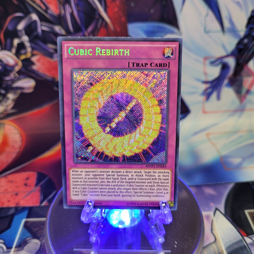 A Secret Rare "Cubic Rebirth" card from the Yugioh Set: The Dark Side of Dimensions Movie Pack: Secret Edition.