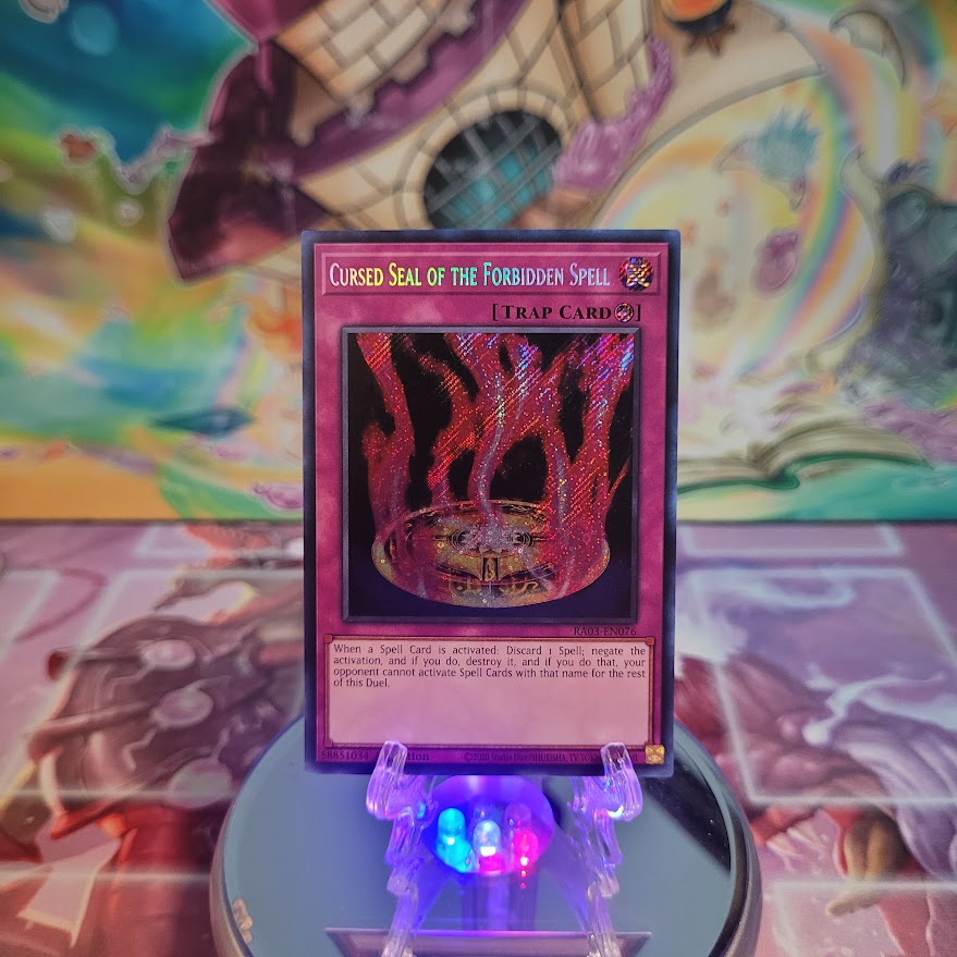 A Secret Rare "Cursed Seal of the Forbidden Spell" card from the Yugioh Set: Quarter Century Bonanza (RA03).