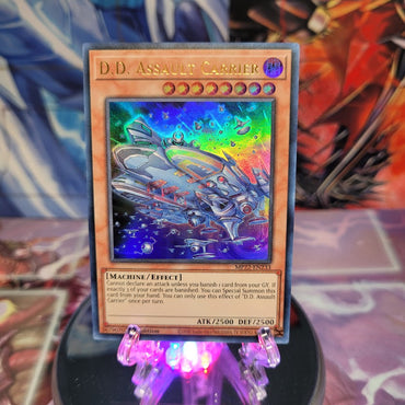 An Ultra Rare "D.D. Assault Carrier" card from the Yugioh 2022 Tin of the Pharaoh's Gods Set (MP22).