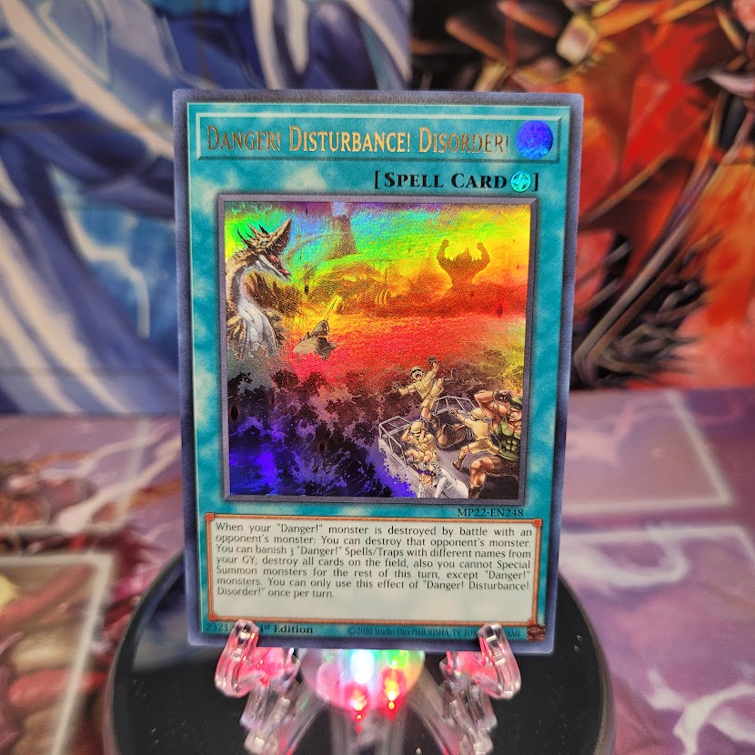 An Ultra Rare "Danger! Disturbance! Disorder!" card from the Yugioh 2022 Tin of the Pharaoh's Gods Set (MP22).