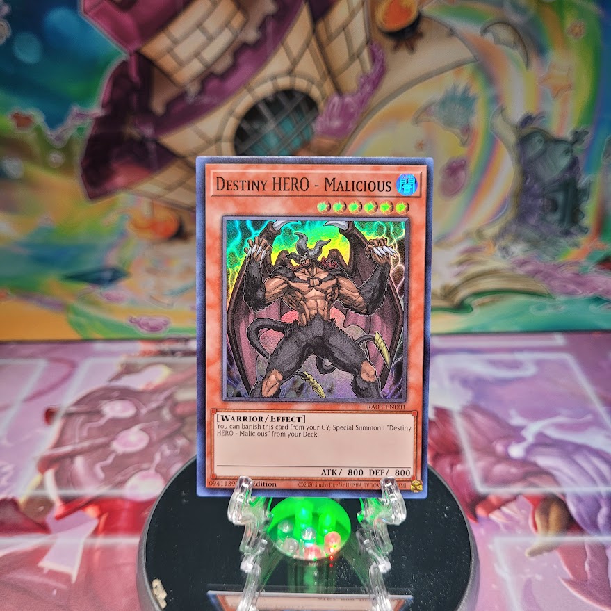 A Super Rare "Destiny Hero - Malicious" card from the Yugioh Set: Quarter Century Bonanza (RA03).