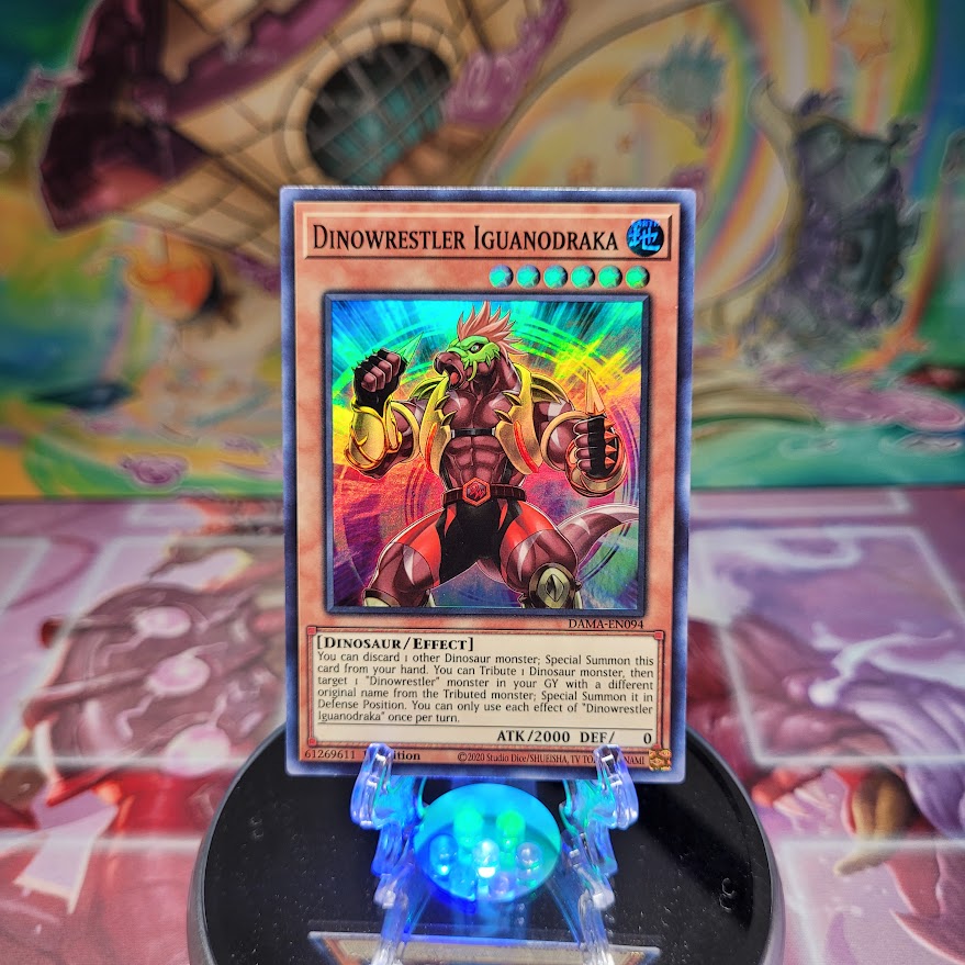 A Super Rare "Dinowrestler Iguanodraka" card from the Yugioh Set: Dawn of Majesty.