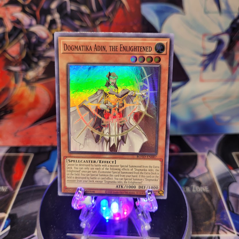 A Super Rare "Dogmatika Adin, the Enlightened" card from the Yugioh Set: Rise of the Duelist.