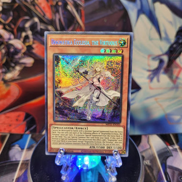 A Prismatic Secret Rare "Dogmatika Ecclesia, the Virtuous" card from the Yugioh 2021 Tin of Ancient Battles.