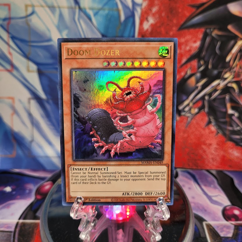 An Ultra Rare "Doom Dozer" card from the Yugioh Set: Magnificent Mavens.