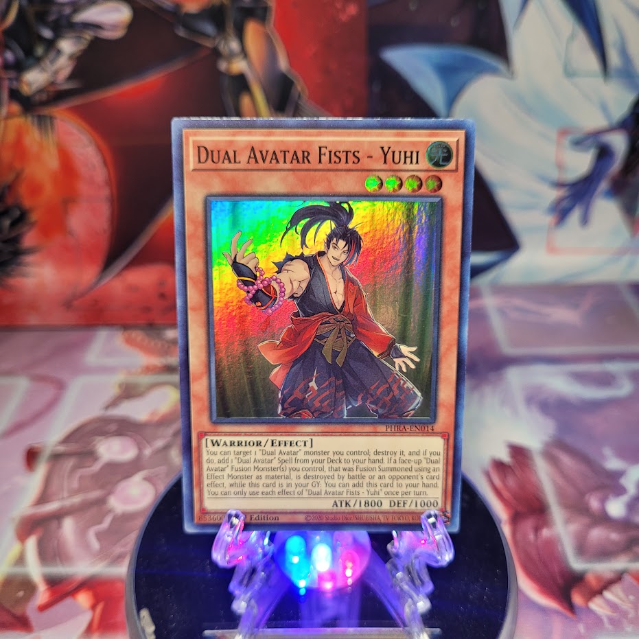 A Super Rare "Dual Avatar Fists - Yuhi" card from the Yugioh Set: Phantom Rage.