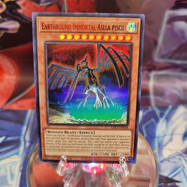 An Ultra Rare Red "Earthbound Immortal Aslla Piscu" card from the Yugioh Set: Legendary Duelists: Season 3.