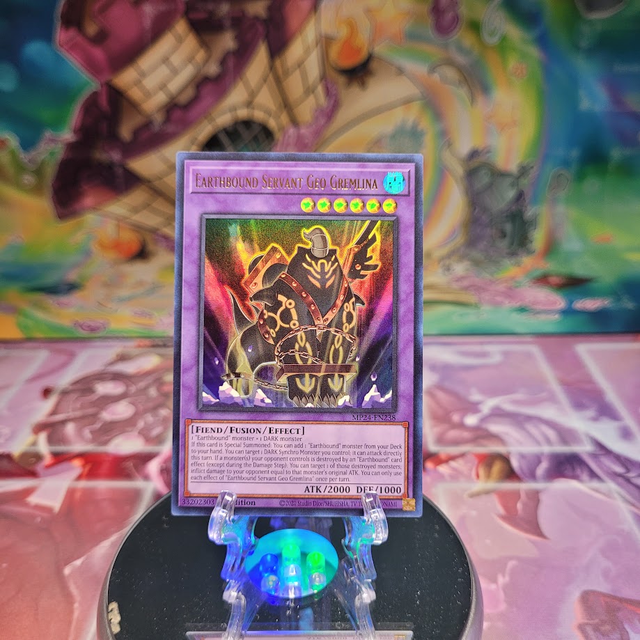 An Ultra Rare "Earthbound Servant Geo Gremlina" card from the Yugioh Set: 25th Anniversary Tin: Dueling Mirrors.