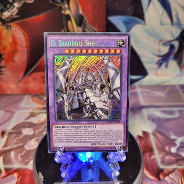 A Secret Rare "El Shaddoll Shekhinaga" card from the Yugioh Set: The New Challengers (NECH).