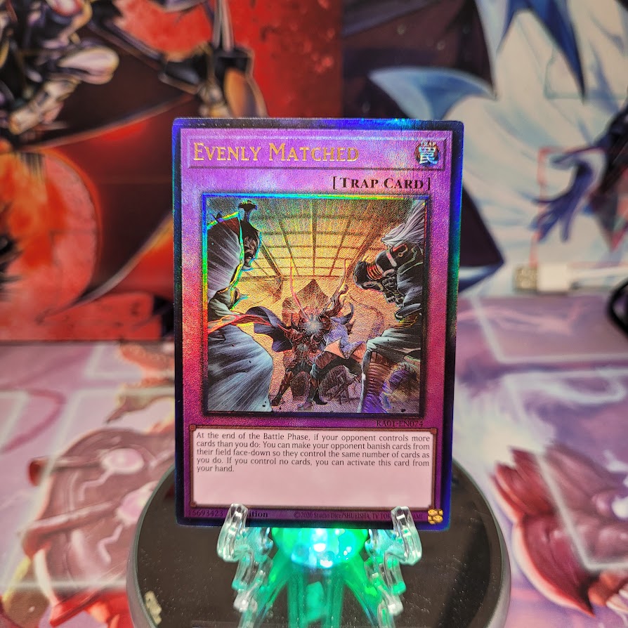 A Prismatic Ultimate Rare "Evenly Matched" card from the Yugioh Set: Rarity Collection 1 (RA01).