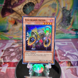 A Super Rare "Evilswarm Ketos" card from the Yugioh Set: Hidden Arsenal 7: Knight of Stars (HA07).