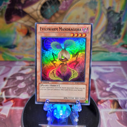 A Super Rare "Evilswarm Mandragora" card from the Yugioh Set: Hidden Arsenal 7: Knight of Stars (HA07).