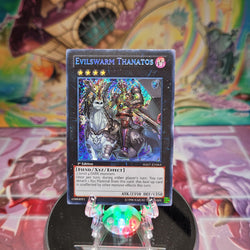 A Secret Rare "Evilswarm Thanatos" card from the Yugioh Set: Hidden Arsenal 7: Knight of Stars (HA07).