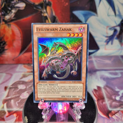 A Super Rare "Evilswarm Zahak" card from the Yugioh Set: Hidden Arsenal 7: Knight of Stars (HA07).