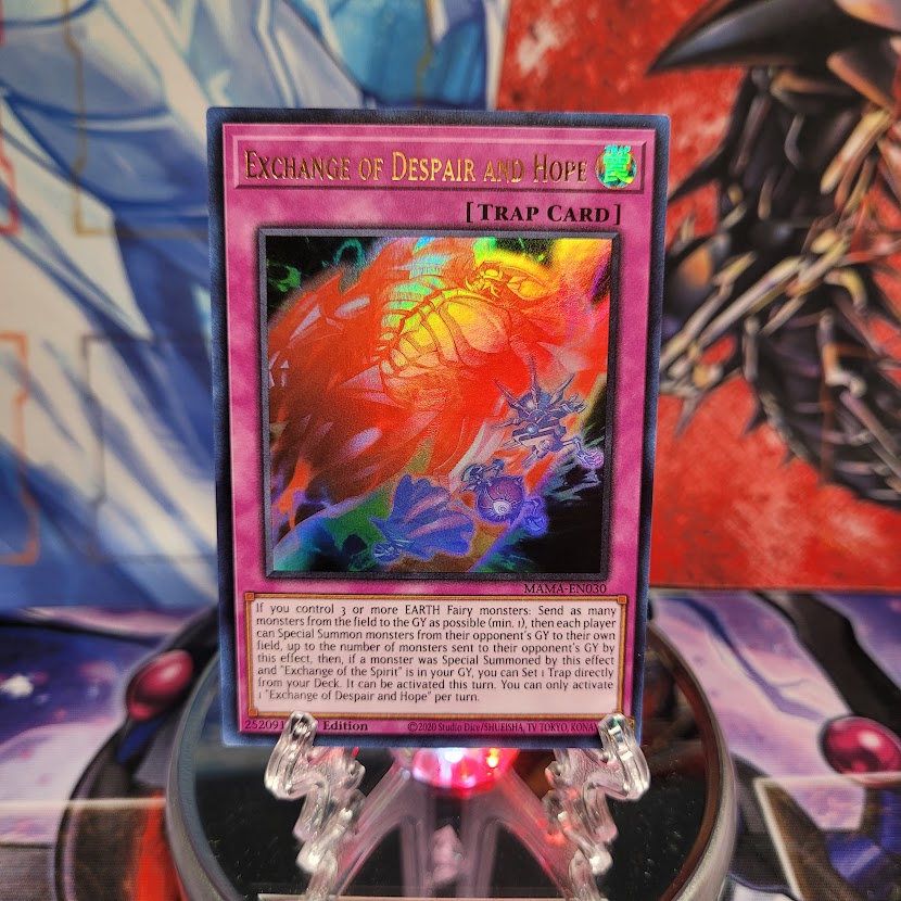 An Ultra Rare "Exchange of Despair and Hope" card from the Yugioh Set: Magnificent Mavens.