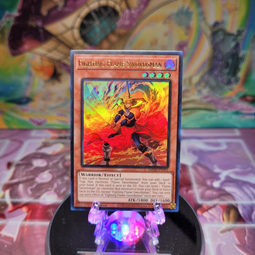 An Ultra Rare "Fighting Flame Swordsman" card from the Yugioh Set: Maze of Millennia.