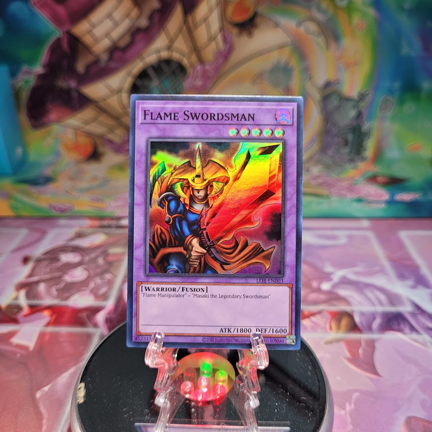 A Super Rare 25th Anniversary "Flame Swordsman" card from the Yugioh Set: The Legend of Blue-Eyes White Dragon.