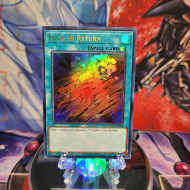 An Ultra Rare "Foolish Return" card from the Yugioh Set: Magnificent Mavens.