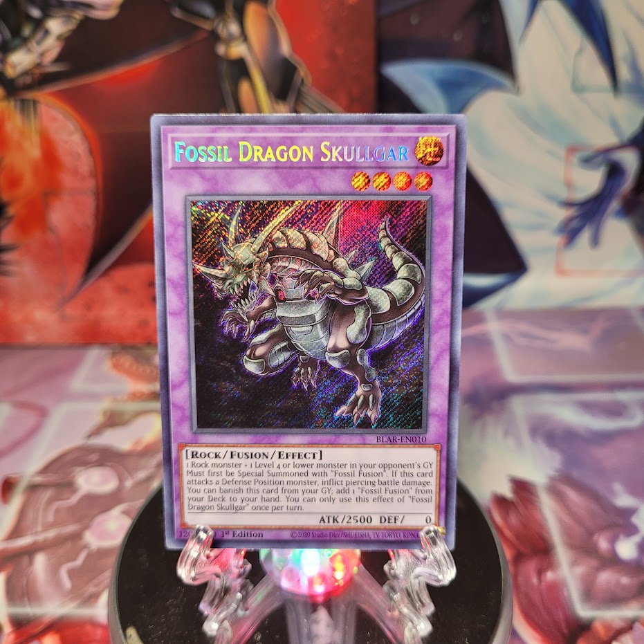 A Secret Rare "Fossil Dragon Skullgar" card from the Yugioh Set: Battles of Legend: Armageddon (BLAR).