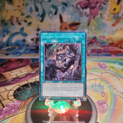 A Secret Rare "Fusion Deployment" card from the Yugioh Set: The Fallen & The Virtuous Structure Deck (CH01).