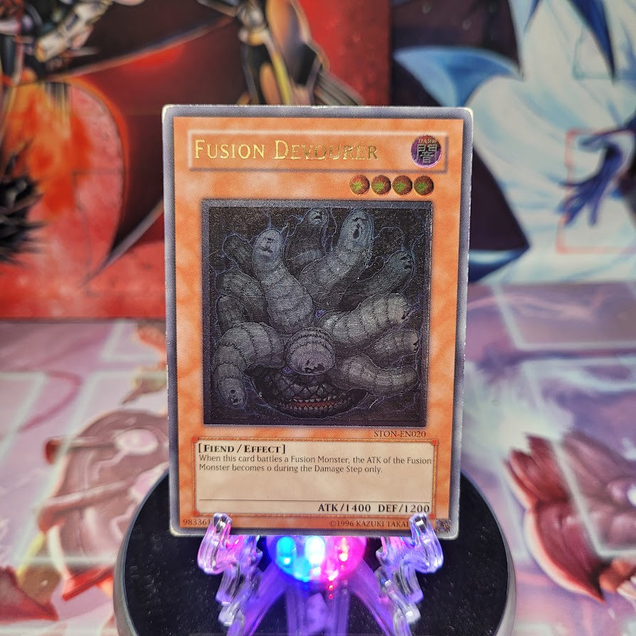 An Ultimate Rare "Fusion Devourer" card from the Yugioh Set: Strike of Neos (STON).