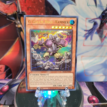 An Ultra Rare "G Golem Rock Hammer" card from the Yugioh Set: Battles of Legend: Crystal Revenge.