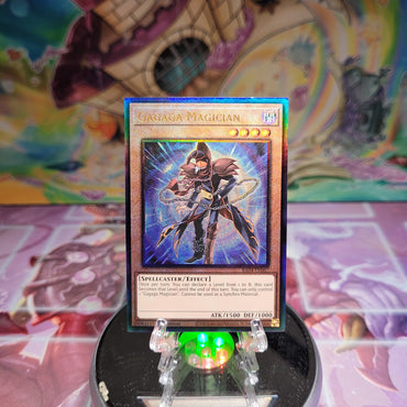 A Prismatic Ultimate Rare "Gagaga Magician" card from the Yugioh Set: Quarter Century Stampede (RA04).