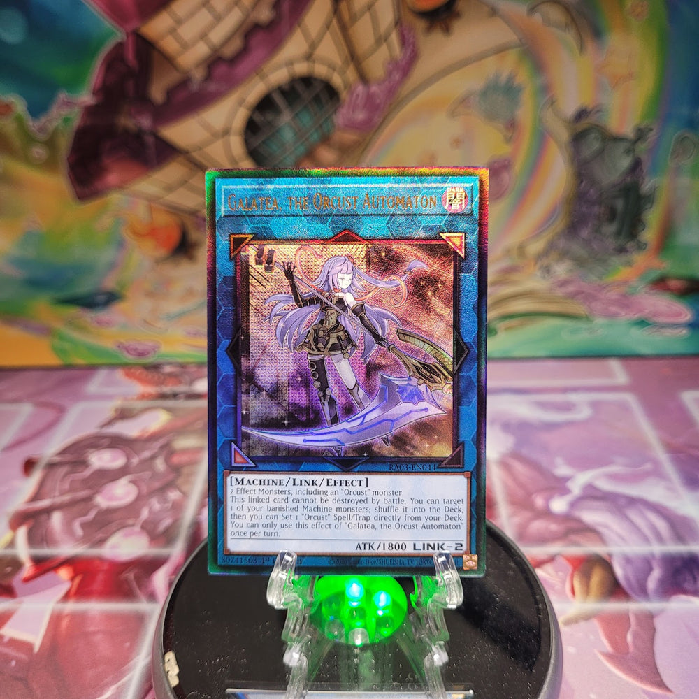 A Prismatic Ultimate Rare "Galatea, the Orcust Automaton" card from the Yugioh Set: Quarter Century Bonanza (RA03).